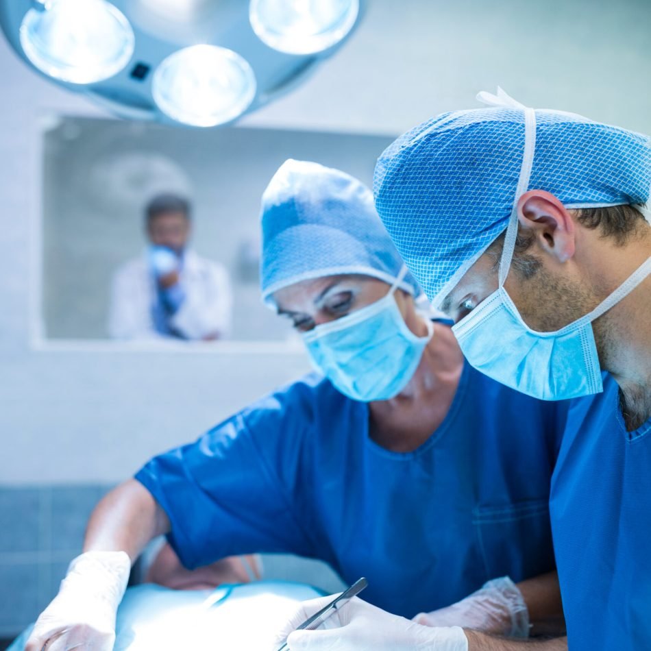 Surgeons performing operation in operation room at the hospital